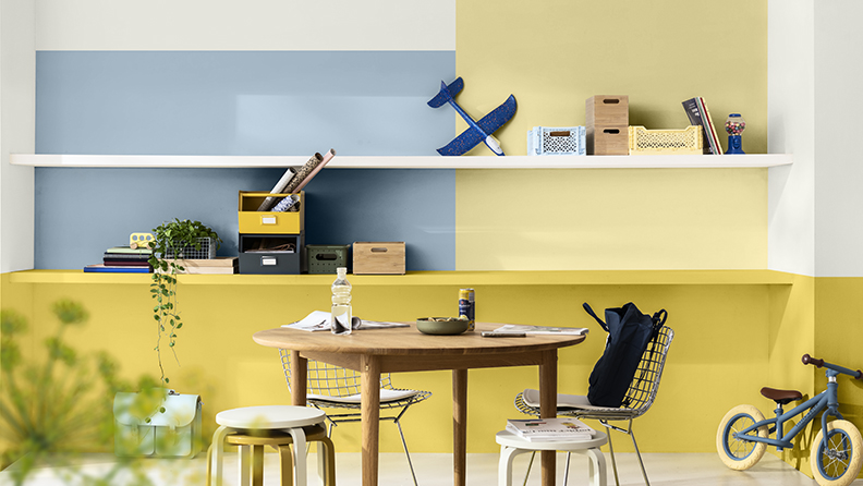 Home office with colour block walls in yellows and blue
