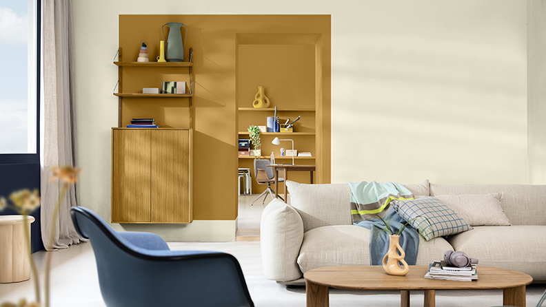 Living room with block of ochre around the doorway and blue chair