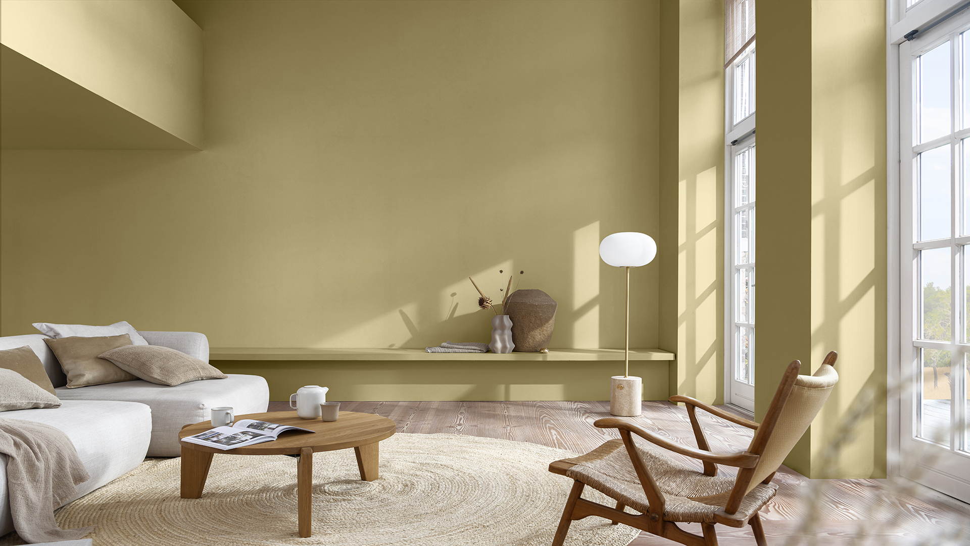 Living room with straw-colored walls and white sofa on the left